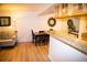 Inviting dining area featuring hardwood floors, complemented by stylish black chairs and a granite countertop at 9263 E Arbor Cir # B, Englewood, CO 80111