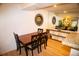 Comfortable dining area with a wooden table set and views into the living space at 9263 E Arbor Cir # B, Englewood, CO 80111
