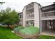 Charming condo exterior with beautiful green space, a balcony, and well-maintained landscaping at 9263 E Arbor Cir # B, Englewood, CO 80111
