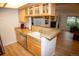 Well-lit kitchen featuring granite countertops, wood cabinets, and stainless steel appliances at 9263 E Arbor Cir # B, Englewood, CO 80111