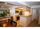 This kitchen has wood cabinets and granite countertops that opens to a dining area at 9263 E Arbor Cir # B, Englewood, CO 80111