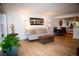 Bright living room showcasing a comfortable couch, decor, and light wood flooring at 9263 E Arbor Cir # B, Englewood, CO 80111