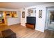 Open-concept living room with a media center and easy flow to kitchen and dining at 9263 E Arbor Cir # B, Englewood, CO 80111