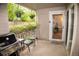 Relaxing patio space with grill, flowers, and an inviting entryway into the home at 9263 E Arbor Cir # B, Englewood, CO 80111