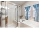 Bathroom featuring soaking tub and glass enclosed shower with bench at 16456 Wagon Pl, Parker, CO 80134