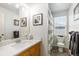 Bright bathroom with a wood vanity, white countertop, decorative mirrors, and a shower and toilet at 16456 Wagon Pl, Parker, CO 80134