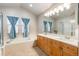 Bright bathroom with a double vanity, tub, and step-in shower at 16456 Wagon Pl, Parker, CO 80134