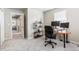 Bedroom with neutral walls featuring a workspace with desk and modern shelving unit with decorative items at 16456 Wagon Pl, Parker, CO 80134