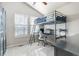 Bedroom featuring a unique lofted bed design with integrated desk and bright natural light from two large windows at 16456 Wagon Pl, Parker, CO 80134