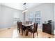 Dining room with hardwood floors, large windows, and a contemporary light fixture at 16456 Wagon Pl, Parker, CO 80134