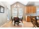 Bright and airy dining room with natural light, a modern chandelier, and direct access to the kitchen at 16456 Wagon Pl, Parker, CO 80134