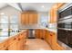 Well-appointed kitchen featuring light wood cabinets, stainless steel appliances, and quartz countertops at 16456 Wagon Pl, Parker, CO 80134