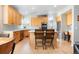 Bright kitchen featuring light wood cabinets, stainless steel appliances, and an island with seating at 16456 Wagon Pl, Parker, CO 80134