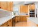 Modern kitchen featuring light wood cabinets, stainless steel appliances, and ample counter space at 16456 Wagon Pl, Parker, CO 80134