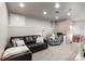 Cozy finished basement living room with a comfortable brown leather sofa and accent chair at 16456 Wagon Pl, Parker, CO 80134