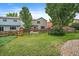 A spacious backyard with lush green grass, enclosed by a wooden fence, offers a private outdoor space at 3528 Morning Glory Dr, Castle Rock, CO 80109