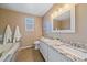 Bright bathroom features a double vanity, granite countertops, and tile flooring at 3528 Morning Glory Dr, Castle Rock, CO 80109