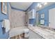Bright bathroom features a tub-shower combo, granite counters and blue walls at 3528 Morning Glory Dr, Castle Rock, CO 80109
