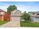 Charming two-story home with a well-manicured lawn, gray siding, brick accents, and an attached two-car garage at 3528 Morning Glory Dr, Castle Rock, CO 80109
