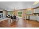 Open concept living and dining area features wood floors, abundant natural light, and backyard access at 3528 Morning Glory Dr, Castle Rock, CO 80109