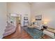 Bright living room with high ceilings, wood floors, a modern rug, and comfortable seating at 3528 Morning Glory Dr, Castle Rock, CO 80109