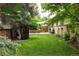 Tranquil backyard oasis featuring a lush lawn, stone patio, and decorative fencing at 6080 S Detroit St, Centennial, CO 80121