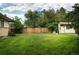 Green backyard featuring a storage shed, stone barbecue, and a well-maintained fence at 6080 S Detroit St, Centennial, CO 80121