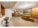 Retro finished basement with bar area, dining space, mountain mural, and built-in shelving for storage at 6080 S Detroit St, Centennial, CO 80121