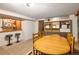 Finished basement area with wood paneled bar, shelving, and table, perfect for entertaining and storage at 6080 S Detroit St, Centennial, CO 80121