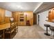 Finished basement with wooden furniture, dining set, and bar, perfect for entertainment and storage at 6080 S Detroit St, Centennial, CO 80121