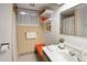 Small bathroom featuring vintage wallpaper, shelving, and a modern sink, creating a unique and functional space at 6080 S Detroit St, Centennial, CO 80121