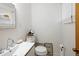 Modern half-bathroom featuring a sleek sink, toilet, and stylish decor at 6080 S Detroit St, Centennial, CO 80121