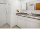 Bright bathroom with double sink vanity, stone countertop, and well-lit mirrors at 6080 S Detroit St, Centennial, CO 80121
