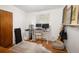 Bedroom featuring a modern standing desk, wooden floors, and bright natural light, creating a home office at 6080 S Detroit St, Centennial, CO 80121