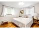 Bright bedroom with a comfortable bed, hardwood floors, and large windows providing ample natural light at 6080 S Detroit St, Centennial, CO 80121