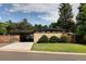 Mid-century modern home with brick facade, covered carport, and well-maintained lawn at 6080 S Detroit St, Centennial, CO 80121