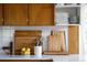 Bright kitchen counter with wooden cabinets, ceramic tile backsplash, and a decorative display of cutting boards at 6080 S Detroit St, Centennial, CO 80121