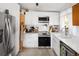 Bright kitchen with modern appliances, white cabinets, and functional layout at 6080 S Detroit St, Centennial, CO 80121