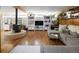 Bright living room featuring a corner wood stove, hardwood floors, and comfy seating at 6080 S Detroit St, Centennial, CO 80121
