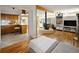 Cozy living room with hardwood floors, fireplace, and view into kitchen at 6080 S Detroit St, Centennial, CO 80121