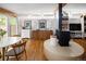Open-concept living and dining area with unique wood-burning stove and natural light at 6080 S Detroit St, Centennial, CO 80121