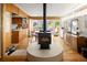 Open-concept living area featuring a kitchen, wood stove, and dining space at 6080 S Detroit St, Centennial, CO 80121