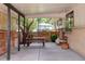 Covered outdoor patio featuring a picnic table, chairs, and a brick exterior wall at 6080 S Detroit St, Centennial, CO 80121