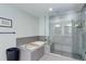 Sleek bathroom with a glass-enclosed shower and luxurious bathtub at 7201 E Quincy Ave # 103, Denver, CO 80237