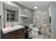 Modern bathroom with stylish stone accent wall and vanity at 7201 E Quincy Ave # 103, Denver, CO 80237