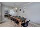 Stylish dining room features a modern light fixture, wood table, and art prints at 7201 E Quincy Ave # 103, Denver, CO 80237