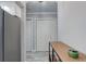 Hallway view with light gray walls, plank floors and white closets at 7201 E Quincy Ave # 103, Denver, CO 80237