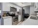 Modern kitchen features stainless steel appliances and white cabinets at 7201 E Quincy Ave # 103, Denver, CO 80237