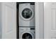 Conveniently stacked washer and dryer in a brightly lit laundry closet at 7201 E Quincy Ave # 103, Denver, CO 80237