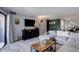 Living room featuring a dark console table, a green accent wall, and a large gray sectional at 7201 E Quincy Ave # 103, Denver, CO 80237